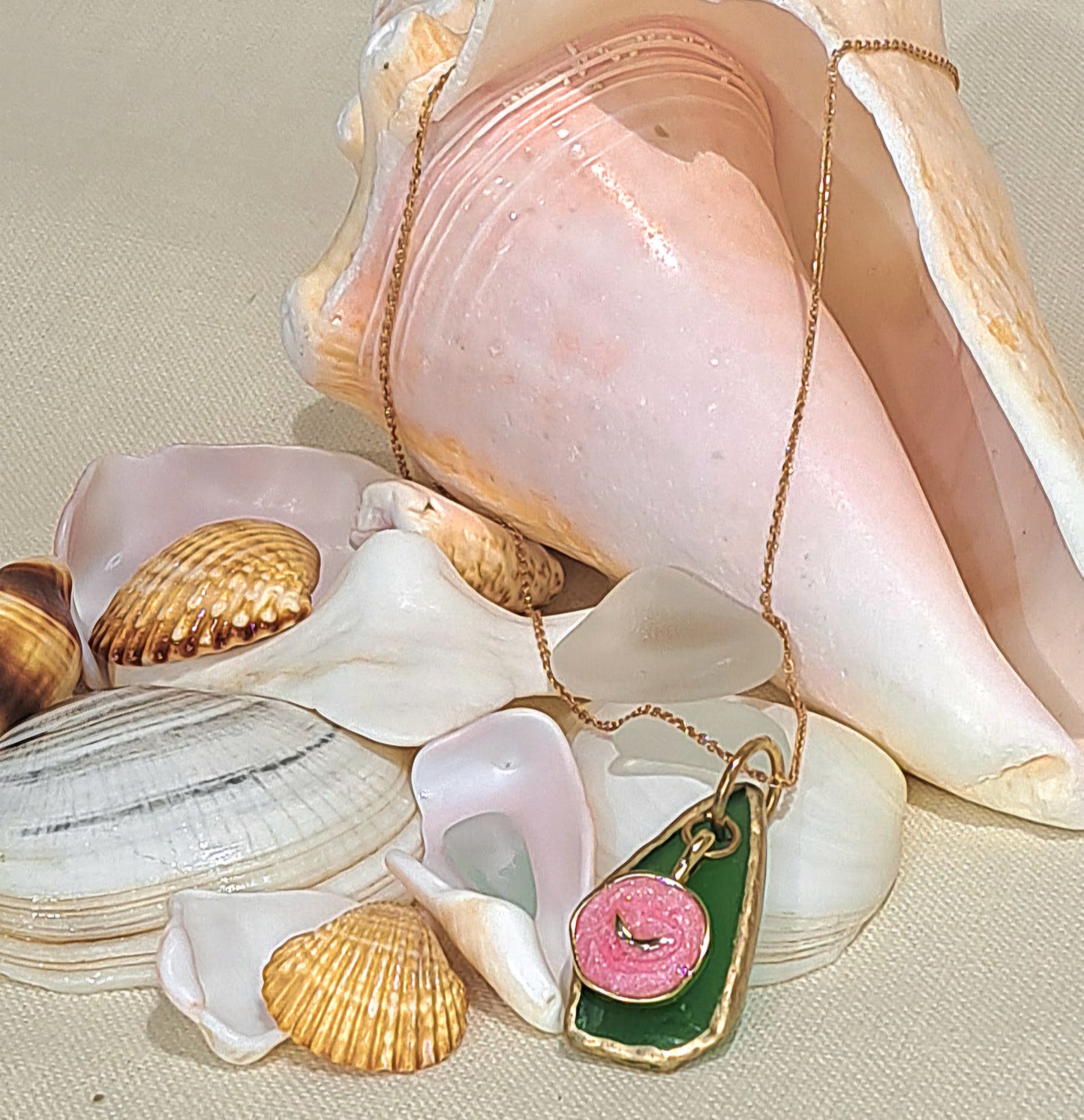 Green Sea Glass pendant necklace with pink whale tail charm.