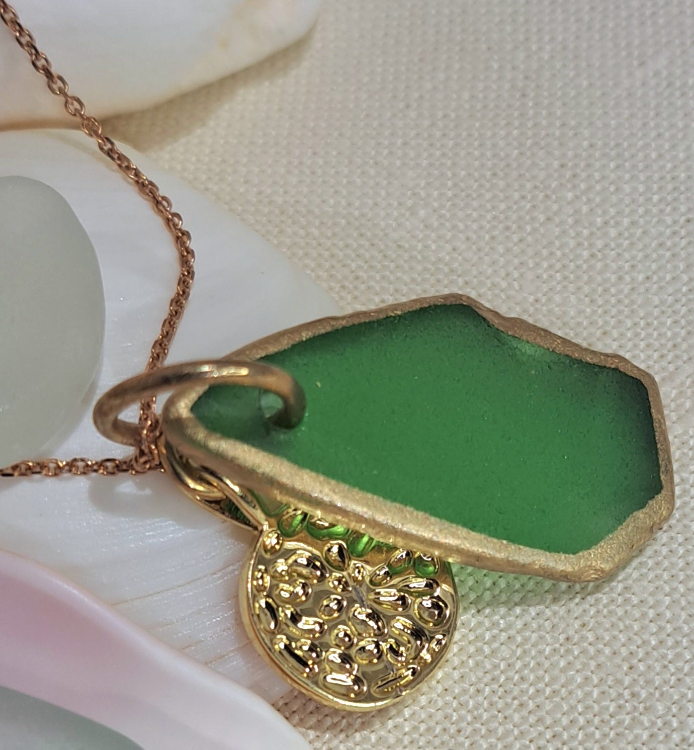 Green Sea Glass pendant necklace with pink whale tail charm.