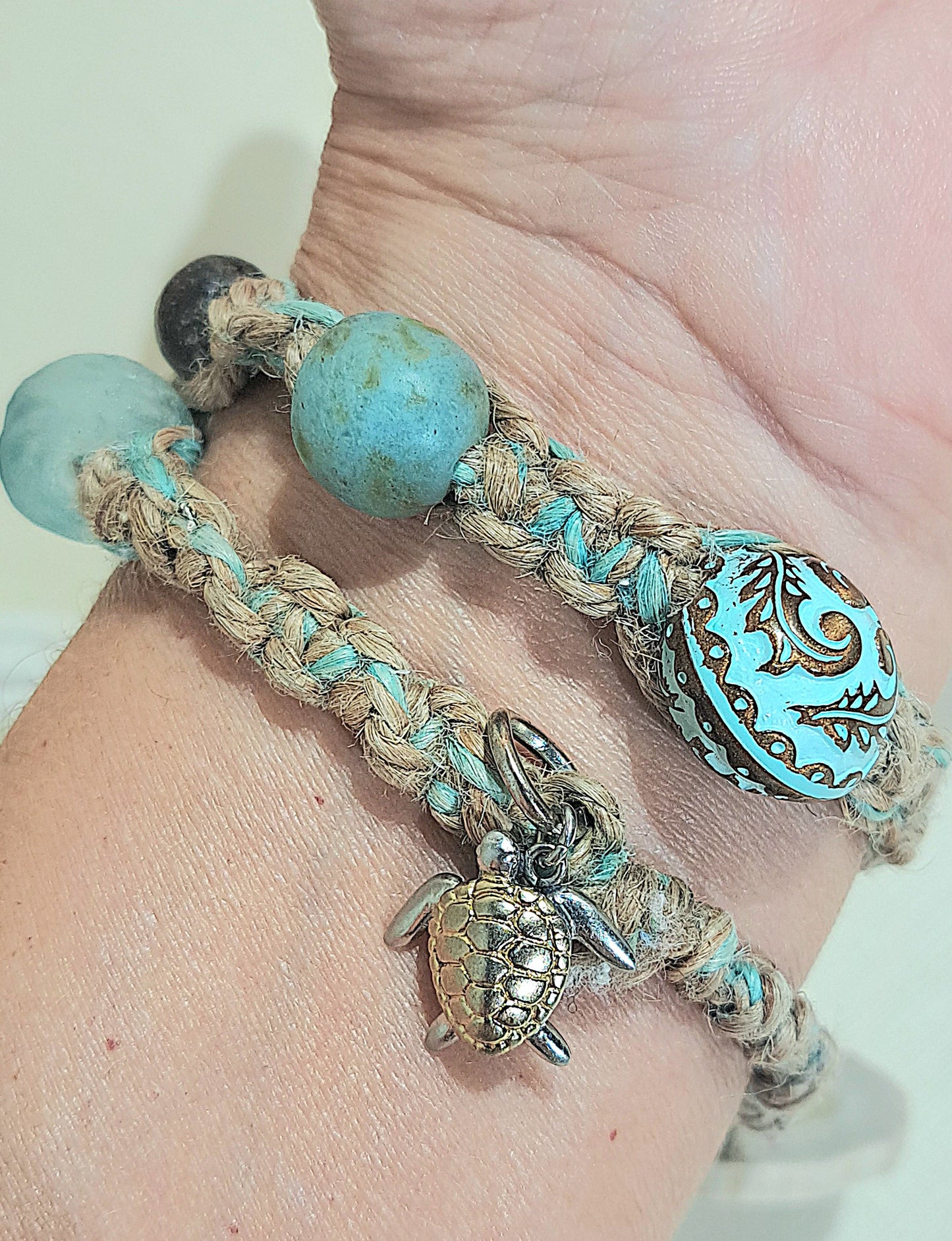 Jute double wrap bracelet with blue African glass, wood, and large metal focal bead.