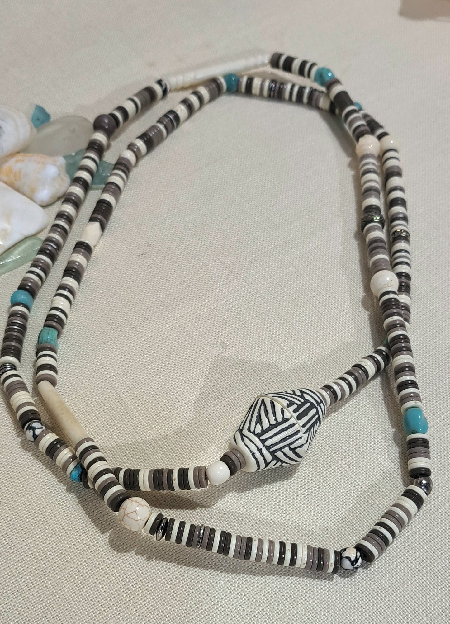 Heishi stretch necklace in neutrals with turquoise accents.