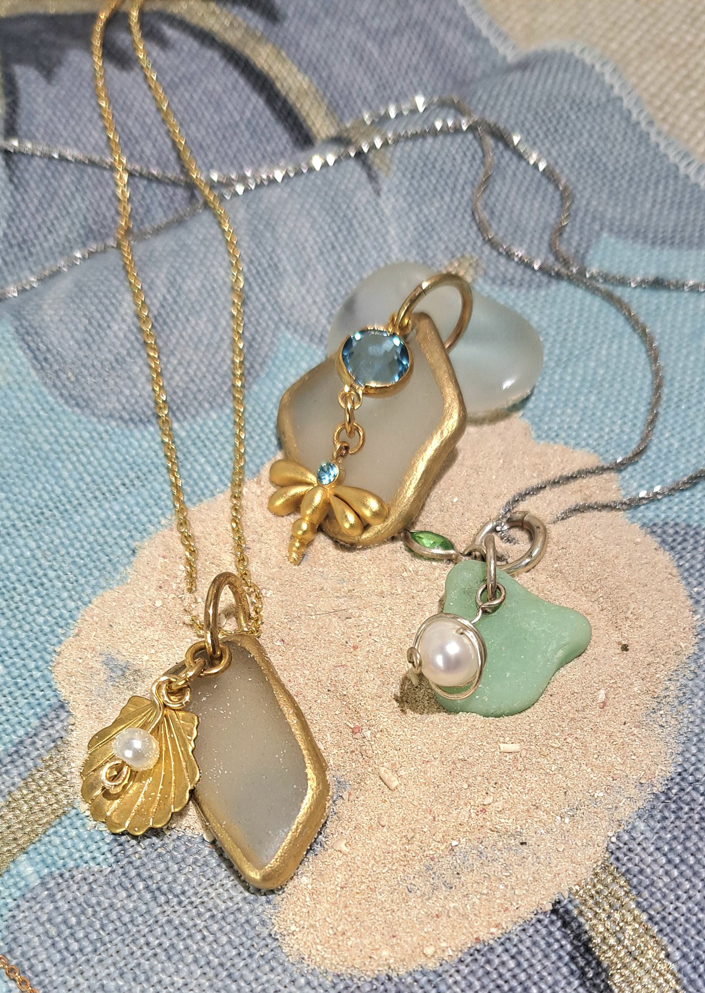 Clear Sea Glass Gold Foil pendant with blue glass charms on gold cable chain.