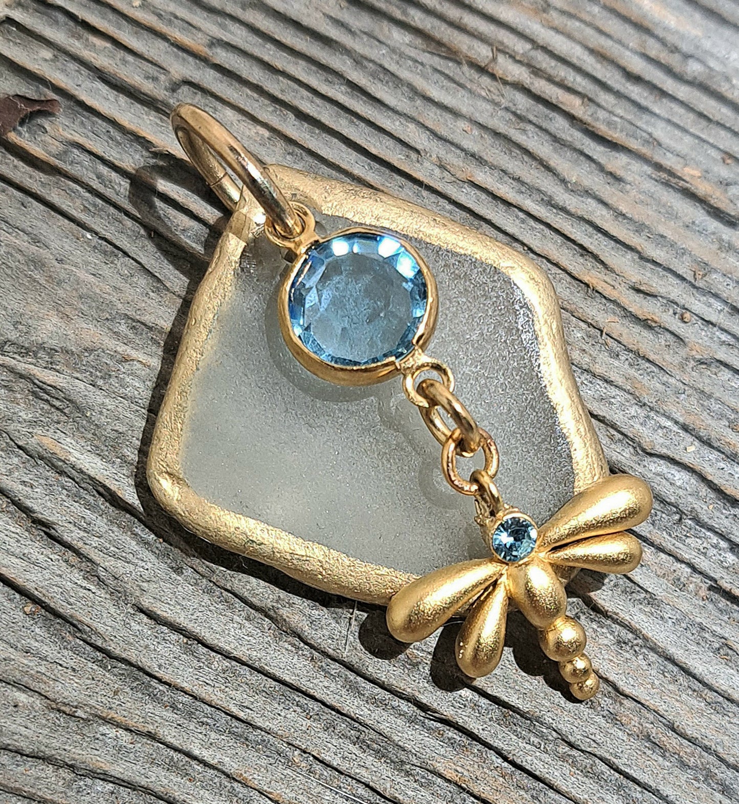 Clear Sea Glass Gold Foil pendant with blue glass charms on gold cable chain.