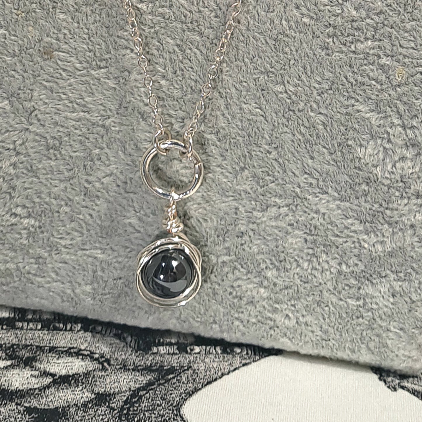 Ladies Hematite wire wrapped pendant on Silver chain.
