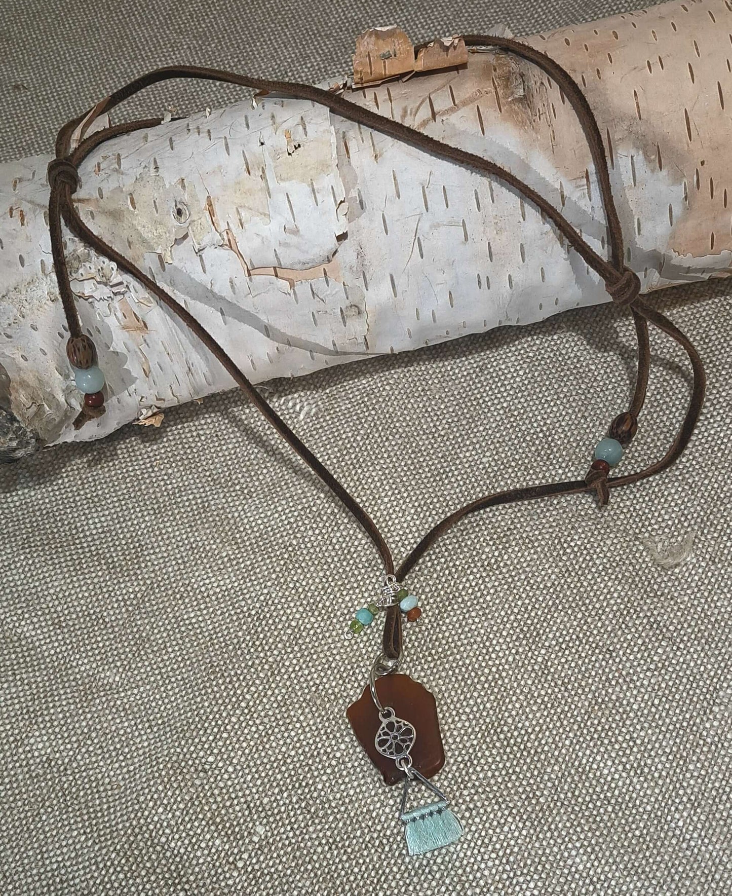 Brown Sea Glass and silver charm with tassel adjustable suede necklace.