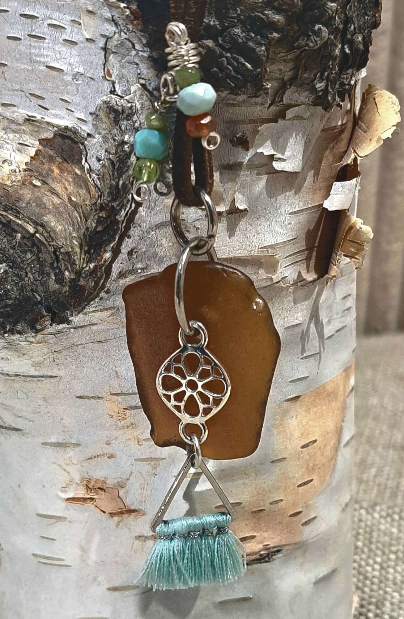Brown Sea Glass and silver charm with tassel adjustable suede necklace.