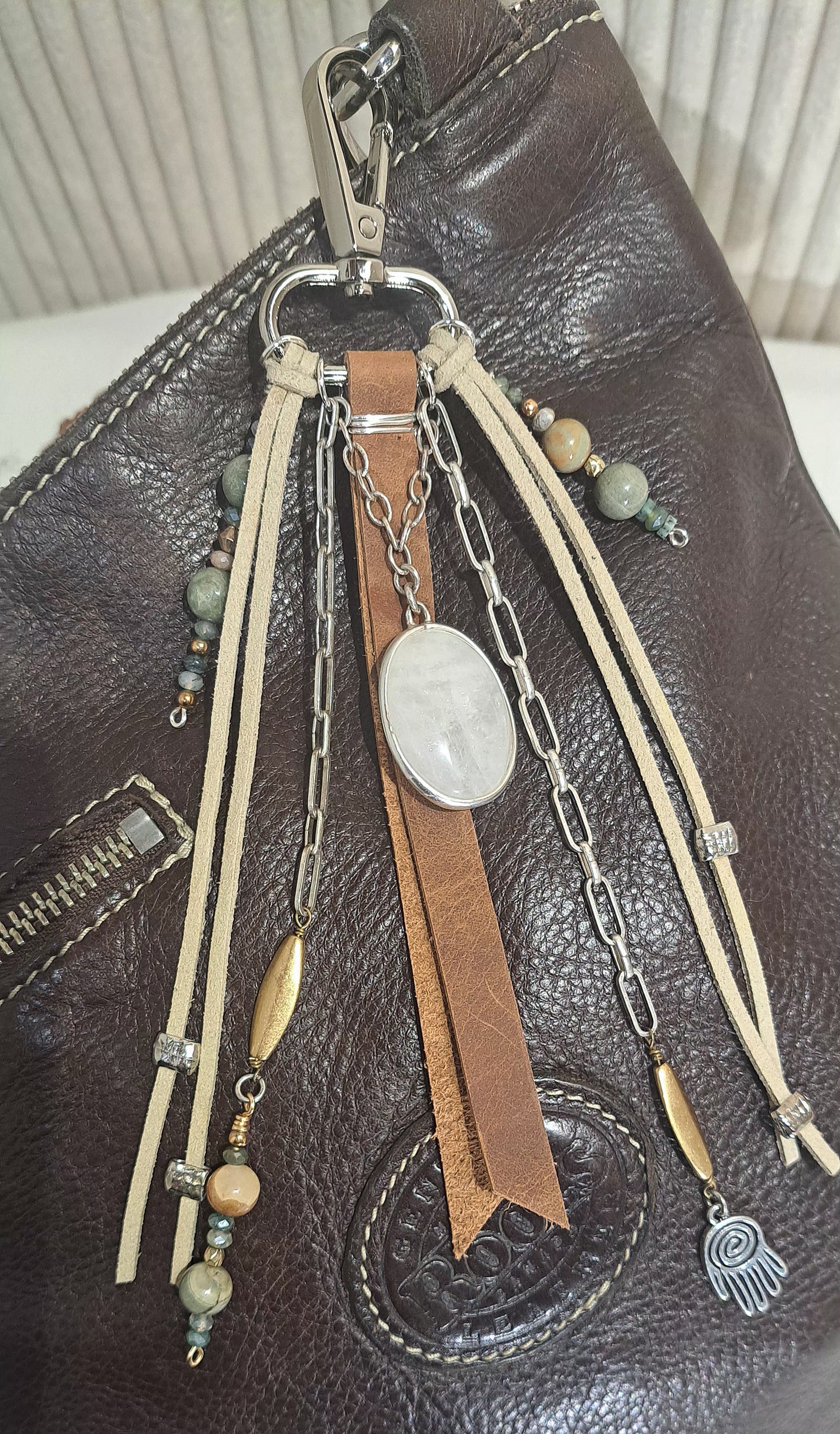 Distressed brown leather bag charm with large ivory quartz focal .