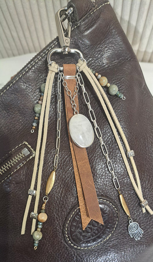 Distressed brown leather bag charm with large ivory quartz focal .