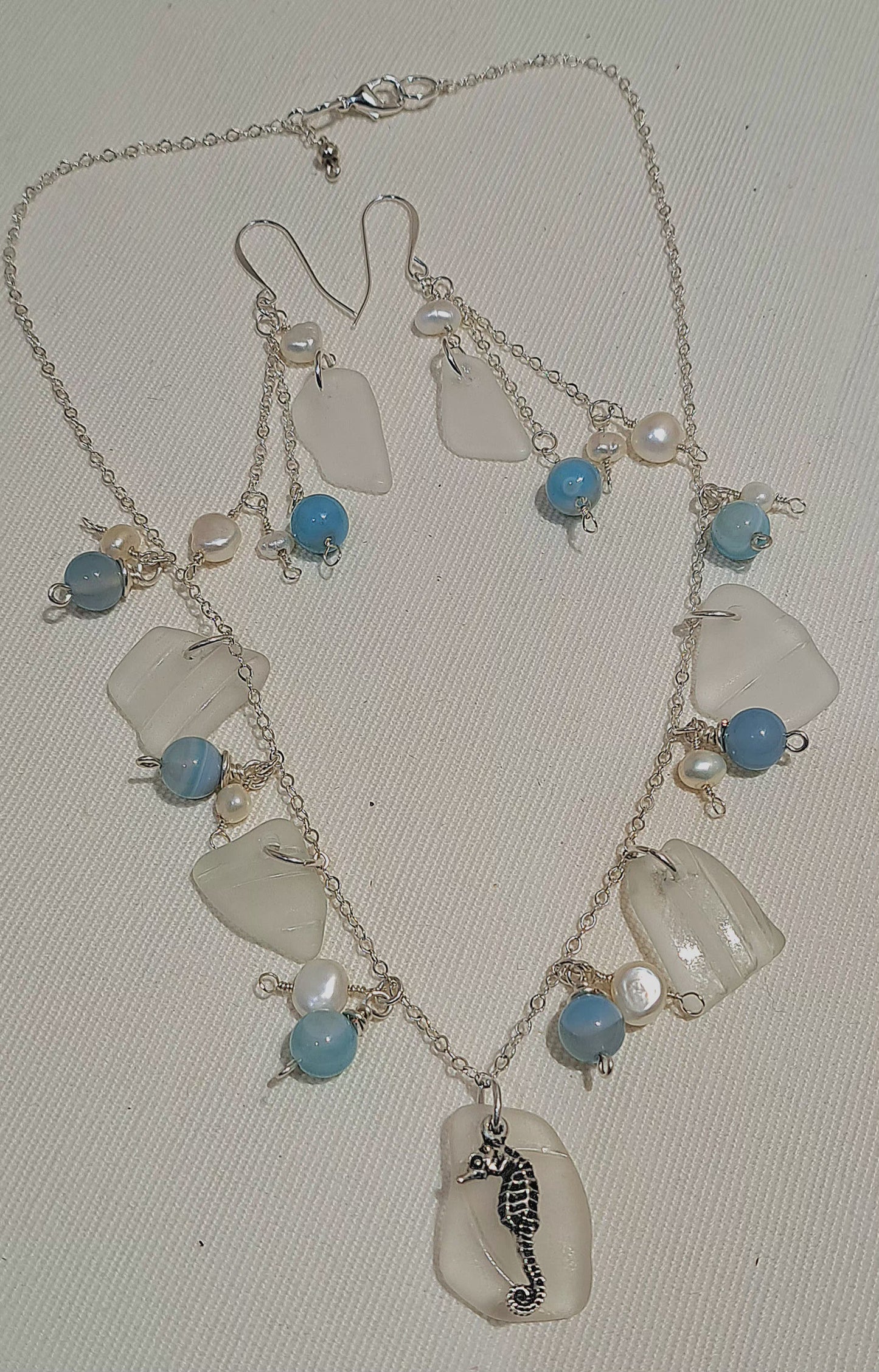 Etched Sea Glass necklace with fresh water pearls and sea blue gemstone beads on silver chain.