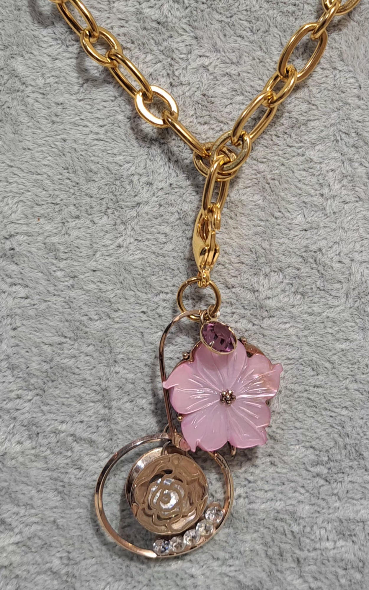 waterproof chunky gold chain necklace with a pink enamel Hibiscus flower and gold circle pendant dotted with rhinestones