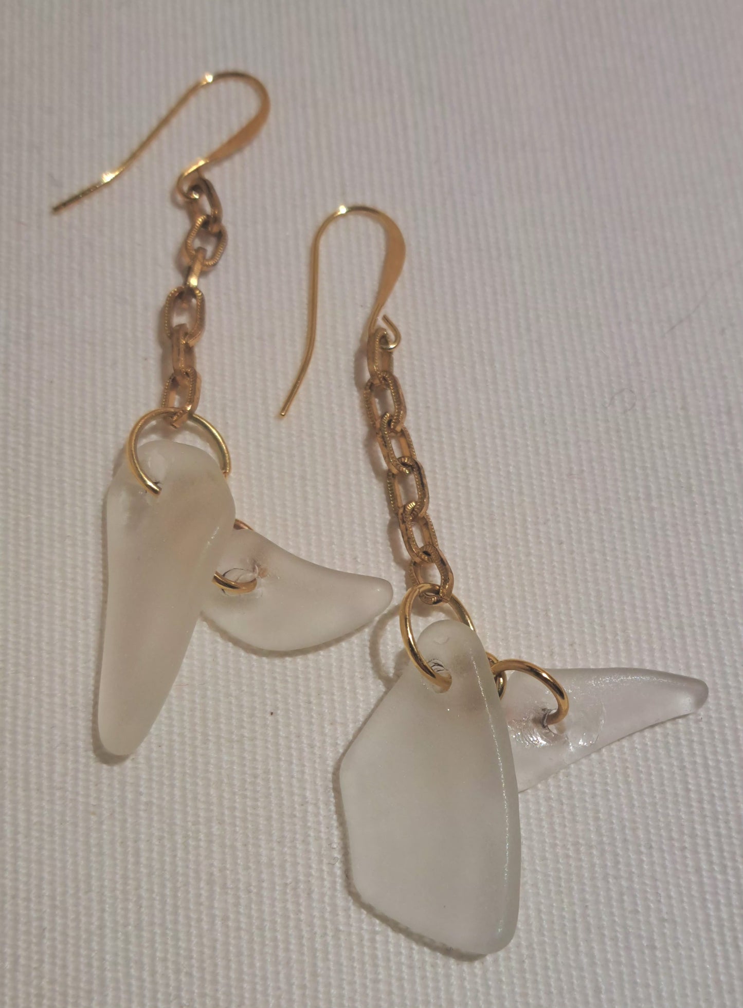 Clear sea glass chip earring on gold chain and shepherd hook ear wires