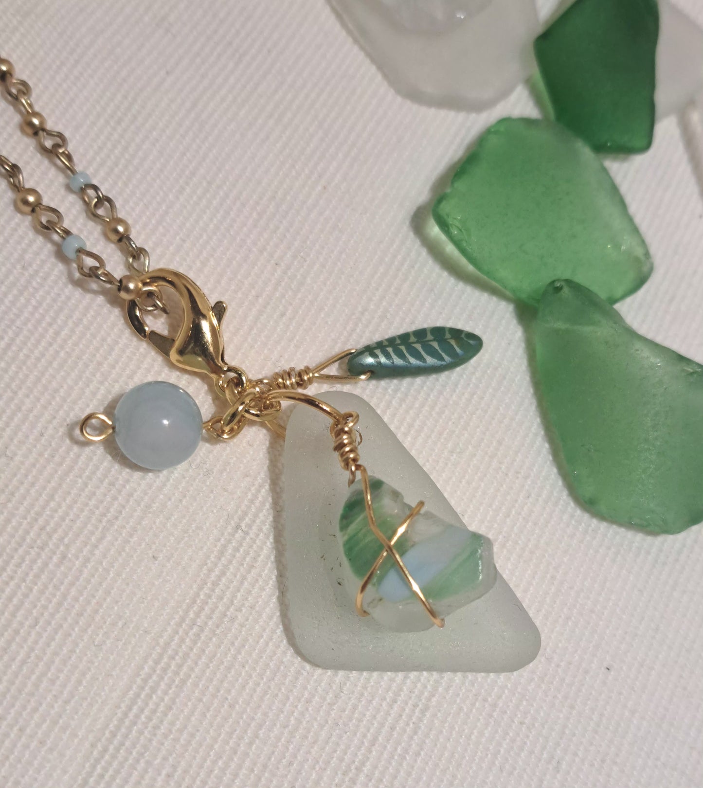 Sea glass necklace with striped chip, Czech leaf, and jade bead.