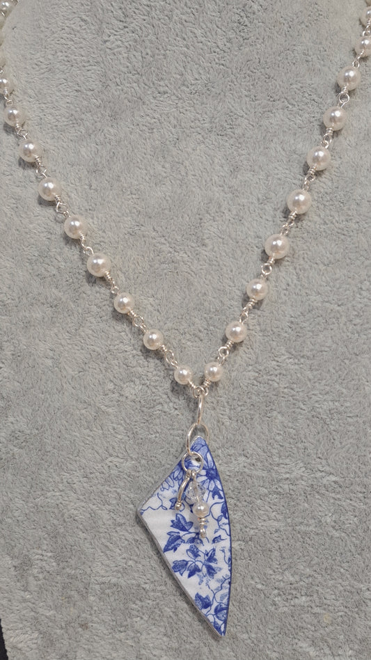 Broken China and faux pearl necklace.