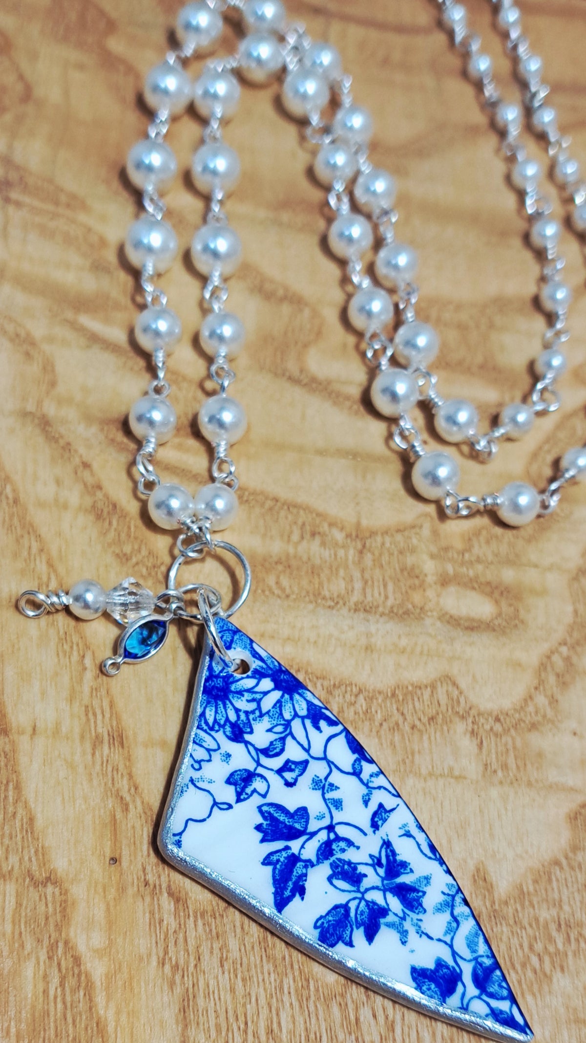 Broken China and faux pearl necklace.