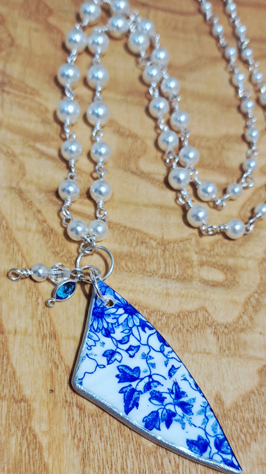 Broken China and faux pearl necklace.