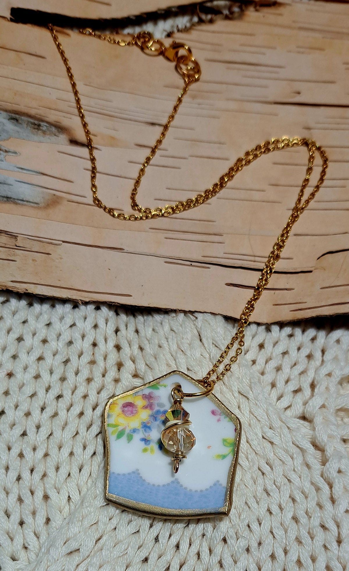 Broken china pendant hung on small loop gold plated chain
